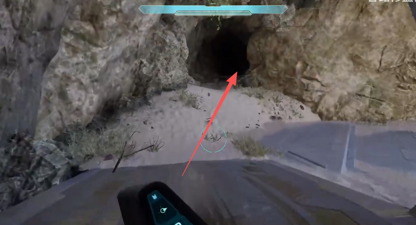 Arrow pointing into the small rock cave beyond the structure
