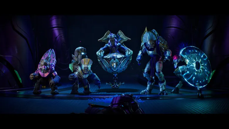 A group of Covenant enemies posing inside a dark chamber