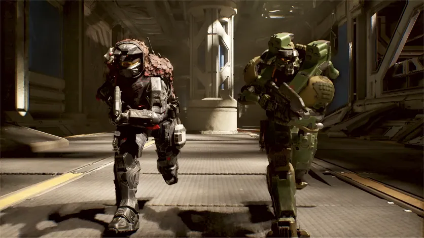 Two Spartans running through a UNSC facility